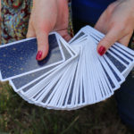 Jane holds a deck of cards.