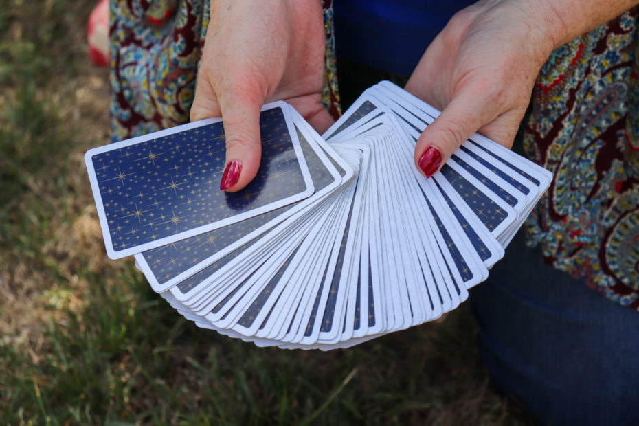 Jane holds a deck of cards.